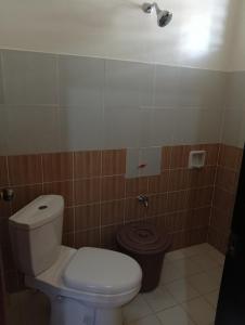 a bathroom with a toilet and a trash can at Cabugao Bed & Breakfast and Dorm in El Nido +27 photos