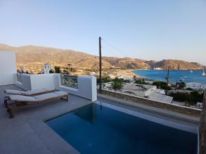 a swimming pool with a view of the ocean at Anemone I w Private Pool 5 minute from beach in Mylopotas
