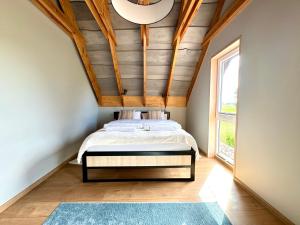 a bedroom with a bed with a wooden ceiling at Suwalskie Klimaty in Kaletnik +39 photos
