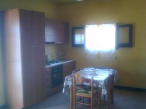 a kitchen with a table and chairs and a window at camping Venere in Granelli