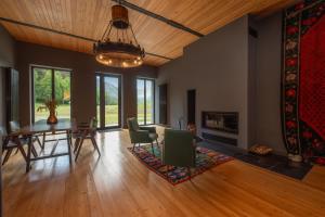 a dining room with a table and chairs and a fireplace at Samzeo Tusheti in Omalo