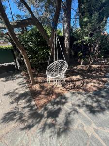 a swing hanging from a tree in a yard at villa Kerlaf in Fréjus