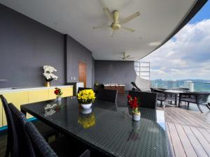 a dining room with a table with flowers on it at The Luxury Penthouse KLCC in Kuala Lumpur