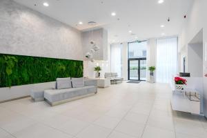 a living room with a couch and a green wall at Luxury apartment, outstanding view, free parking in Tallinn