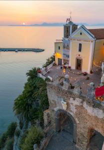 a building on the edge of a body of water at Le Antiche Volte suite in Agropoli