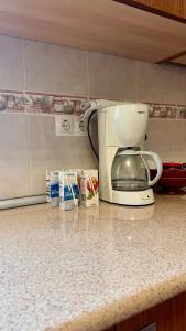 a kitchen counter with a coffee maker and milk at Casa Rural Alcubillas in Las Alcubillas Altas