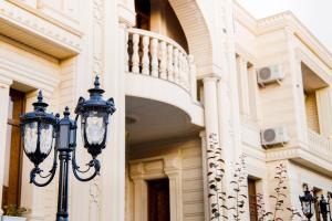 a street light in front of a building with a staircase at Hotel Dali Samarkand in Samarkand