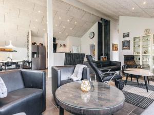 a living room with leather chairs and a table at 5 star holiday home in Brovst in Brovst