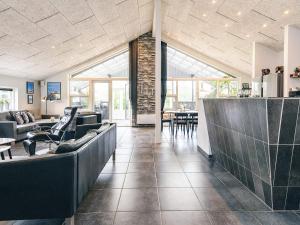 a lobby with couches and chairs and a table at 5 star holiday home in Brovst in Brovst