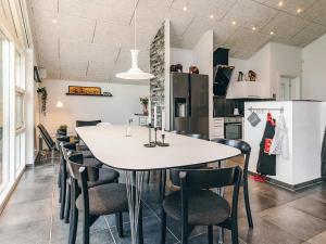 a kitchen and dining room with a table and chairs at 5 star holiday home in Brovst in Brovst +45 photos