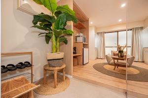 a living room with a potted plant on a table at Mi-HOTEL SUGAMO in Tokyo