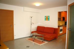 a living room with a red couch and a table at Haus Zisser in Sankt Jakob im Walde