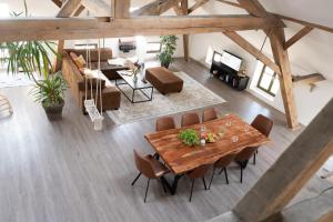 an overhead view of a living room with a table and chairs at Sauna Oase - stay play relax in Tacherting