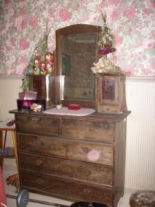 a wooden dresser with a mirror on top of it at Brinkin Wanha Pappila in Kokkola +13 photos