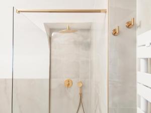 a bathroom with a shower with a glass door at Lamurè Luxury Suite in Bari +29 photos