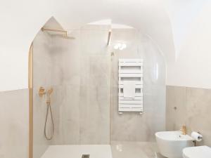 a bathroom with a shower and a toilet and a sink at Lamurè Luxury Suite in Bari