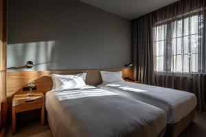 a bedroom with two beds and a window at Samzeo Kvareli in Kvareli