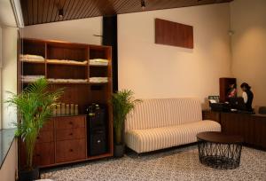 a living room with a couch and a table at The Big Bridge- A Boutique Hotel On A Bridge in Rishīkesh