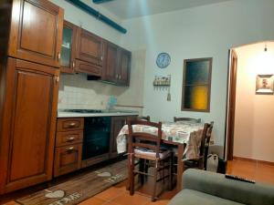 a kitchen with a table and a dining room at LA CASA CHE VORREI in Crotone
