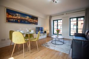 a living room with a table and chairs and a couch at Saint Patrick's District Apartments in Dublin