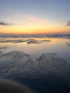 a view of the beach at sunset at Z' Evita in Nieuwpoort
