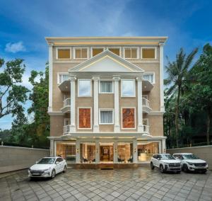 two cars parked in front of a building at The Grand in Thekkady