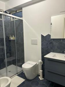 a bathroom with a shower and a toilet and a sink at Villa Ragona Taormina in Taormina +31 photos