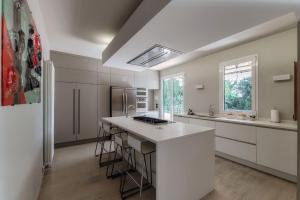 a kitchen with white cabinets and a white counter top at Villa Marta by Quokka 360 - 15 minutes from the centre of Como in San Fermo della Battaglia