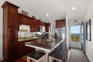 a kitchen with wooden cabinets and a large counter top at Baywatch C10 in Pensacola Beach