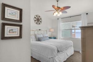 a bedroom with a bed and a ceiling fan at Baywatch C10 in Pensacola Beach +67 photos