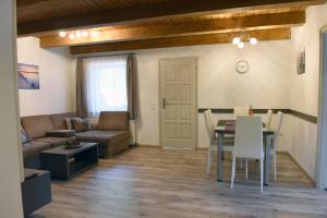 a living room with a table and a couch at Eleven Apartman Agárd in Gárdony