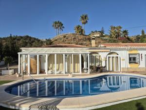 a house with a swimming pool in front of it at Casa Eladio - El Morche in Huit