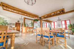 a dining room with wooden tables and chairs at Sächsische Bildungs- und Begegnungsstätte Windmühle Seifhennersdorf in Seifhennersdorf