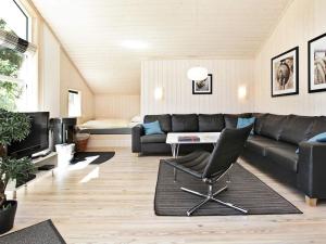 a living room with a couch and a table at Splendid holiday home with view in Großenbrode