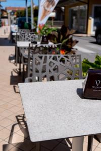 a table with a laptop sitting on top of it at Hotel Laura in Cavallino-Treporti