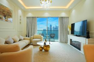 a living room with a television and a large window at Grande Downtown Dubai Luxury 2BR Apt with Burj Khalifa & Dubai Fountain Views in Dubai