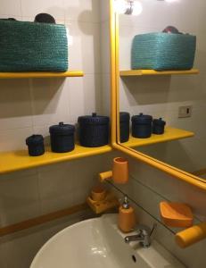 a bathroom with a sink and a mirror at Appartamento Cristalli di Sale in San Vito lo Capo