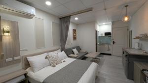 a bedroom with a bed and a living room at 和光寓所-自助加Line取密碼 in Hung-i-li