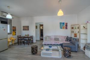 a living room with a couch and a table at Cretan Blue Bungalow Chania in Chania