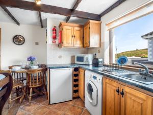a kitchen with a sink and a dishwasher at Tigh An Bheachaire in Carraroe +8 photos