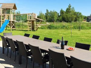 a table and chairs with a playground in the background at Luxury Pool Villa by Sea - By Traum Ferienwohnungen in Marielyst +21 photos