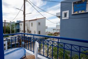 a balcony with a table and a view of the ocean at Psaras Apartments in Stalís