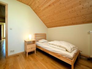a bedroom with a bed and a wooden ceiling at Cosy Holiday Home in Durbuy with Garden in Durbuy