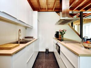 a kitchen with white cabinets and a sink at Cosy Holiday Home in Durbuy with Garden in Durbuy