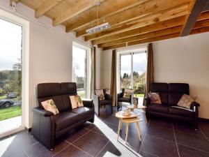 a living room with leather chairs and a table at Cosy Holiday Home in Durbuy with Garden in Durbuy +32 photos