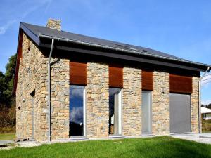 a stone house with a black roof at Cosy Holiday Home in Durbuy with Garden in Durbuy