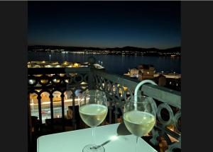 two glasses of white wine sitting on a balcony at Casa Mama in Vigo