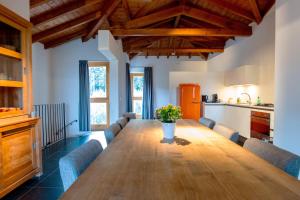 a dining room with a long wooden table and chairs at Tenuta Madonnina in Castiglione di Sicilia