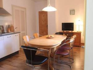 a kitchen and dining room with a wooden table and chairs at Wohnung in Tabarz Thüringen in Waldnähe in Tabarz