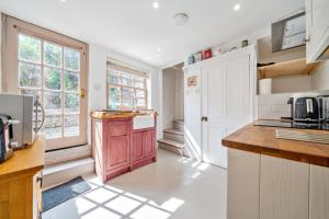 a kitchen with white cabinets and a counter top at 136 Southgate St, Bury St Edmunds in Bury Saint Edmunds